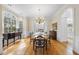 Formal dining room with hardwood floors, large windows, chandelier, and classic decor for elegant gatherings at 12101 Lockhart Ln, Raleigh, NC 27614