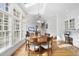 Bright dining room featuring a skylight, hardwood floors, and a table set for six guests at 12101 Lockhart Ln, Raleigh, NC 27614