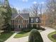 Beautifully landscaped brick home with well-manicured lawn and circular driveway at 12101 Lockhart Ln, Raleigh, NC 27614