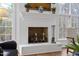Bright brick fireplace with a white mantle decorated with vases and decorative plants at 12101 Lockhart Ln, Raleigh, NC 27614