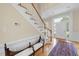 Welcoming foyer featuring a staircase, a seating bench, and hardwood flooring at 12101 Lockhart Ln, Raleigh, NC 27614