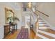 Grand foyer with hardwood floors, staircase, ornate mirror, and elegant chandelier creating a welcoming entrance at 12101 Lockhart Ln, Raleigh, NC 27614