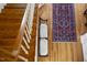 Traditional foyer with oak staircase and colorful decorative rug on the hardwood floors at 12101 Lockhart Ln, Raleigh, NC 27614