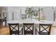 Bright kitchen features white cabinets, countertops, and a large island with seating for three at 12101 Lockhart Ln, Raleigh, NC 27614