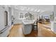 Open kitchen with island, breakfast bar, white cabinetry, skylights, and an eat-in kitchen at 12101 Lockhart Ln, Raleigh, NC 27614
