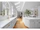 Bright kitchen with skylights, white cabinets, an island, and hardwood floors at 12101 Lockhart Ln, Raleigh, NC 27614