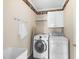 A well-equipped laundry room featuring modern appliances and ample storage at 12101 Lockhart Ln, Raleigh, NC 27614