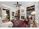 Cozy living room with fireplace, bookshelves, and an adjacent powder room at 12101 Lockhart Ln, Raleigh, NC 27614