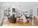Sunlit living room with hardwood floors, fireplace, and ample seating with a large picture window at 12101 Lockhart Ln, Raleigh, NC 27614