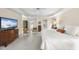 Bright main bedroom with ceiling fan, plush carpet, and large TV on dresser at 12101 Lockhart Ln, Raleigh, NC 27614