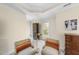 Bright sitting room with plush carpet, vintage dresser, chairs and view of the back yard at 12101 Lockhart Ln, Raleigh, NC 27614