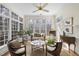 Bright sunroom with many windows, wood floors, neutral colors, comfortable seating, and natural light at 12101 Lockhart Ln, Raleigh, NC 27614