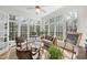 Bright sunroom with large windows offering a view of the surrounding greenery, and comfortable seating at 12101 Lockhart Ln, Raleigh, NC 27614