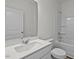 Well-lit bathroom features a modern vanity with a white countertop and a combined shower and tub at 127 N Keatts Winner Ct, Wilson's Mills, NC 27520