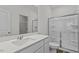 Bathroom with white cabinets, quartz countertops, and glass-enclosed shower at 127 N Keatts Winner Ct, Wilson's Mills, NC 27520