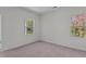 Bedroom with neutral carpet and two windows overlooking a green space at 127 N Keatts Winner Ct, Wilson's Mills, NC 27520