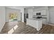 Modern kitchen with stainless steel appliances, kitchen island, and sliding glass door to backyard at 127 N Keatts Winner Ct, Wilson's Mills, NC 27520