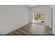 An empty bedroom with vinyl flooring and sliding glass doors leading outside at 135 N Keatts Winner Ct, Clayton, NC 27520