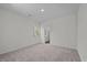 An empty bedroom with carpet flooring, natural light, and neutral paint at 135 N Keatts Winner Ct, Clayton, NC 27520