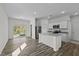 Modern kitchen island featuring granite countertops, a sink, and a breakfast bar in an open-concept layout at 135 N Keatts Winner Ct, Clayton, NC 27520