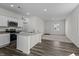 Bright kitchen with granite countertops, white cabinetry, and modern appliances, seamlessly connected to the living area at 135 N Keatts Winner Ct, Clayton, NC 27520