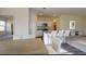 Open-concept kitchen featuring modern appliances, granite countertops, and a breakfast bar with seating at 135 N Keatts Winner Ct, Clayton, NC 27520