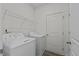 The laundry room includes a washer, a dryer, and a wire rack for additional storage at 135 N Keatts Winner Ct, Clayton, NC 27520