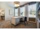 Bright office space featuring modern desk, large windows and custom shelving providing functionality at 1411 Chrysalis Pl, Apex, NC 27502