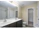A functional bathroom boasts a double vanity and a shower, freshly painted with modern fixtures at 1536 Ricochet Dr, Raleigh, NC 27610