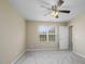 A bright, airy bedroom features a large window and ceiling fan, freshly painted and carpeted at 1536 Ricochet Dr, Raleigh, NC 27610