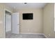 Bedroom with ceiling fan, neutral walls, carpeted floor, and television mounted on wall at 1536 Ricochet Dr, Raleigh, NC 27610