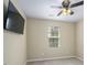 Bedroom features ceiling fan, neutral walls, carpeted floors, and a television at 1536 Ricochet Dr, Raleigh, NC 27610
