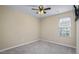 Cozy carpeted bedroom has a ceiling fan, neutral wall color, and natural light at 1536 Ricochet Dr, Raleigh, NC 27610