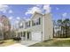 Two-story home showing the side view with gray siding, an attached garage, and a well-manicured lawn at 1536 Ricochet Dr, Raleigh, NC 27610