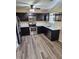 Charming kitchen featuring new wood flooring, stainless steel appliances, and modern countertops at 1536 Ricochet Dr, Raleigh, NC 27610