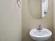 Bright powder room featuring a pedestal sink, modern lighting, and neutral paint at 1536 Ricochet Dr, Raleigh, NC 27610