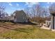 A large backyard featuring a patio with dining and fire pit, with lush green space at 1603 N Alston Ave, Durham, NC 27701