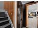 View of staircase leading to finished basement with accent paneling and open doorway at 1603 N Alston Ave, Durham, NC 27701