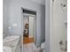 Bathroom showing a view into the hallway with a sink vanity, toilet, and tiled shower at 1603 N Alston Ave, Durham, NC 27701