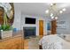 Bedroom with hardwood floors, fireplace, mounted tv, and ornate gold mirror on the wall at 1603 N Alston Ave, Durham, NC 27701