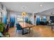 Dining room features a wooden table, blue chairs, blue curtains, and hardwood floors at 1603 N Alston Ave, Durham, NC 27701