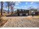 Two-story home featuring two garages and basketball hoop on a gravel drive at 1603 N Alston Ave, Durham, NC 27701