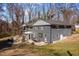 Large backyard with patio, fire pit, and outdoor dining set. Features lush lawn and mature trees at 1603 N Alston Ave, Durham, NC 27701