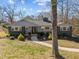 Charming gray home with a well-maintained lawn, inviting walkway, and beautiful landscaping details at 1603 N Alston Ave, Durham, NC 27701