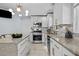 Bright kitchen featuring white cabinets, stainless steel appliances, granite countertops, and modern lighting at 1603 N Alston Ave, Durham, NC 27701