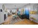Bright living room featuring blue curtains, hardwood floors, and a comfortable sofa at 1603 N Alston Ave, Durham, NC 27701