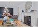 Cozy living room featuring hardwood floors, marble fireplace, accent chairs, and modern decor at 1603 N Alston Ave, Durham, NC 27701