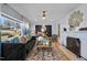 Bright living room features a cozy fireplace, plush seating, and large windows at 1603 N Alston Ave, Durham, NC 27701