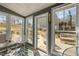 Bright sunroom with plenty of windows shows patio with egg chair and outdoor sofa at 1603 N Alston Ave, Durham, NC 27701