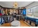 Spacious walk-in closet with custom shelves, cabinets, hardwood floors, and a large window at 1603 N Alston Ave, Durham, NC 27701